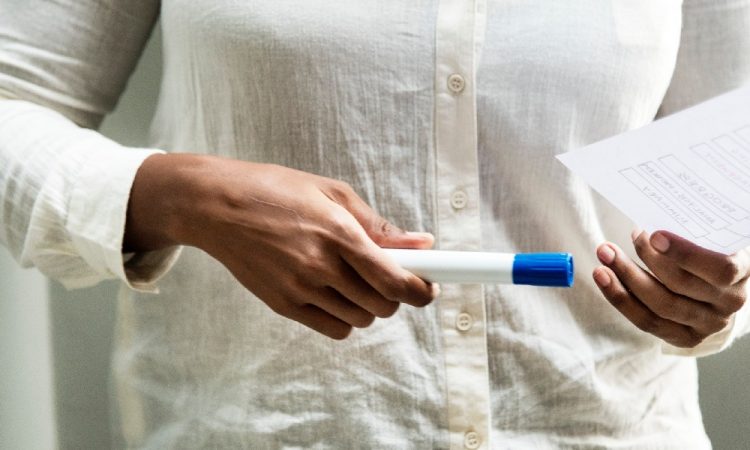 image of woman holding a marker